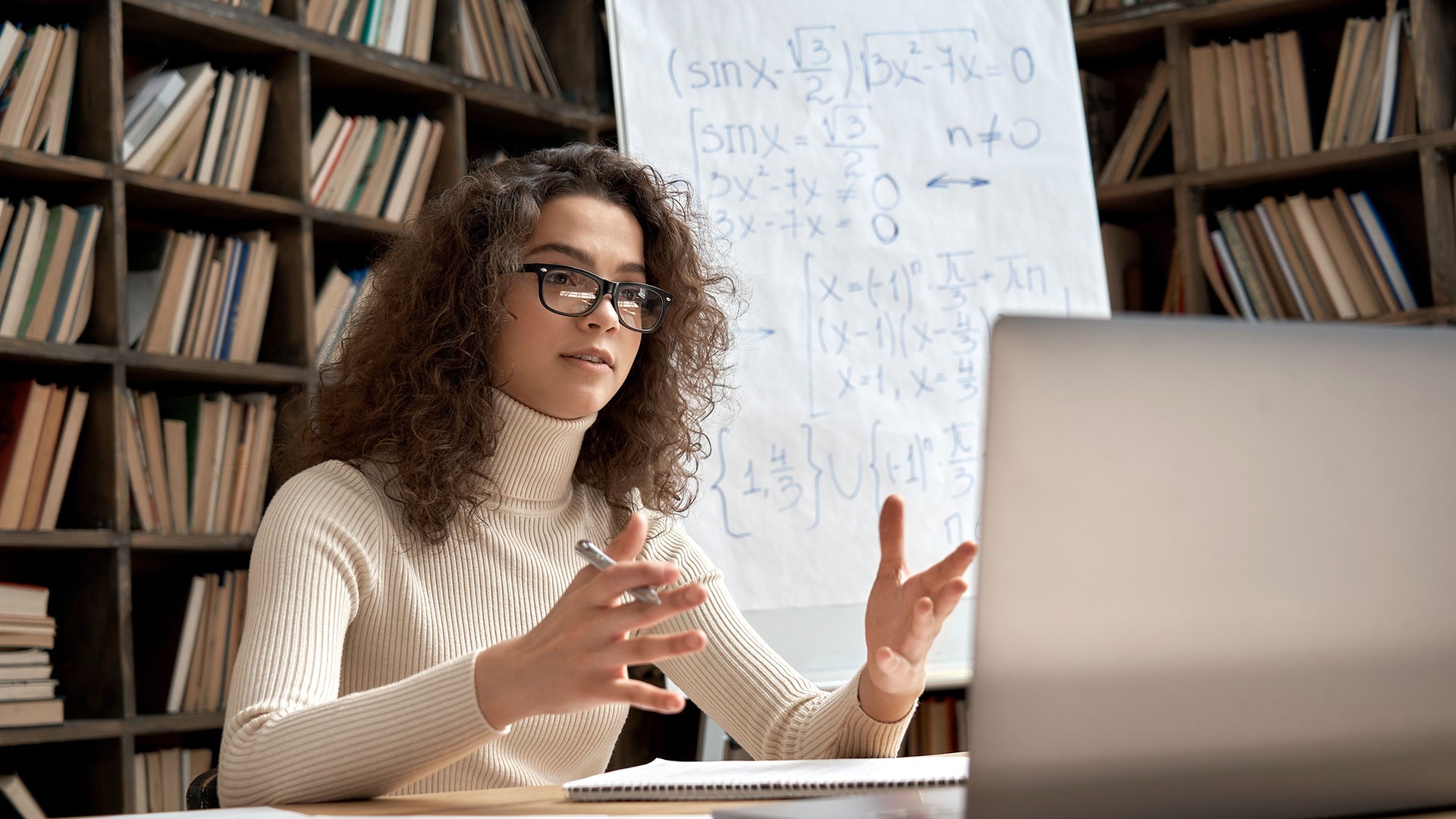 Teacher looking at webcam talking in virtual classroom