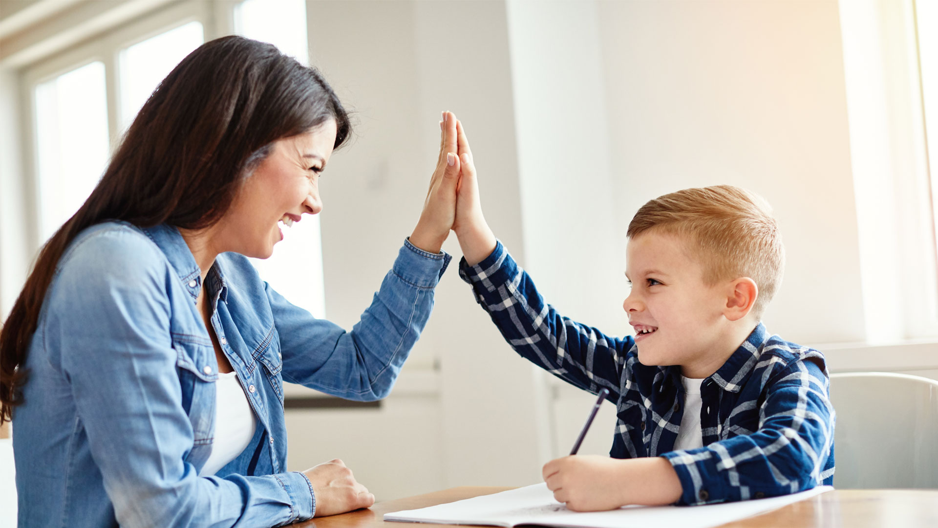 A lady and kid high fiving