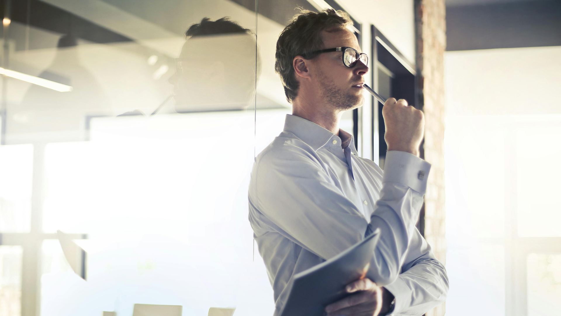 Man with button shirt thinking